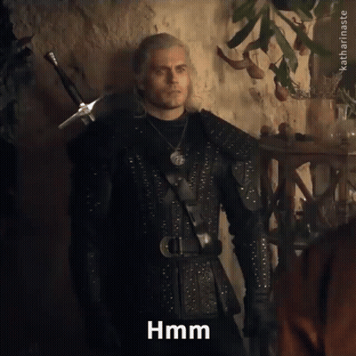 A Man In A Knight 'S Outfit Is Standing In Front Of A Wall And Says Hmm GIF