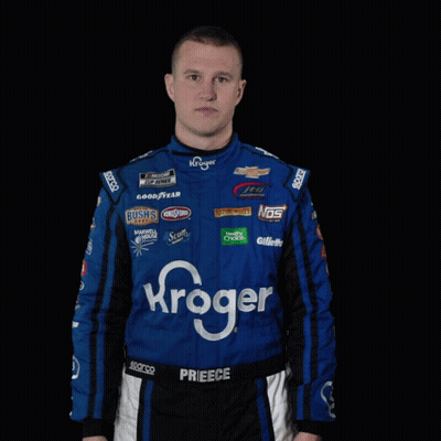A Man In A Kroger Racing Suit Is Standing With His Hands Outstretched GIF