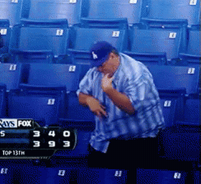 A Man In A La Hat Is Standing In Front Of A Scoreboard That Says Fox GIF