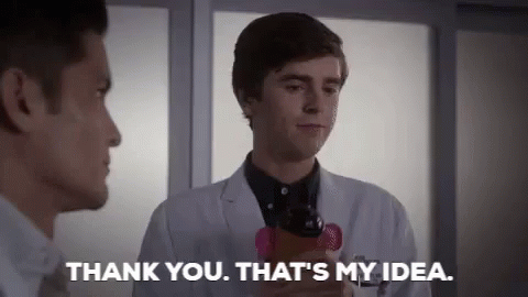 A Man In A Lab Coat Is Holding A Cell Phone And Talking To Another Man In A Hospital Room . GIF