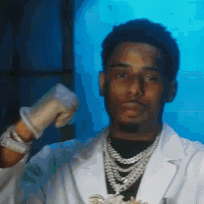 A Man In A Lab Coat Is Wearing Gloves And A Necklace GIF