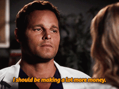 A Man In A Lab Coat Talks To A Woman And Says I Should Be Making A Lot More Money GIF