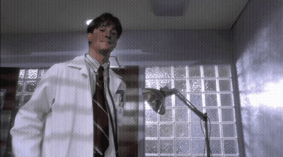A Man In A Lab Coat With The Number 7 On The Front GIF