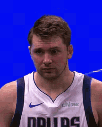A Man In A Lakers Jersey Is Standing In The Stands Holding A Can Of Soda . GIF