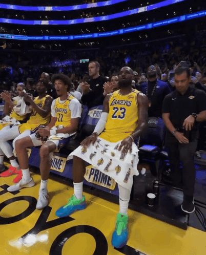 A Man In A Lakers Jersey Sits In The Stands GIF