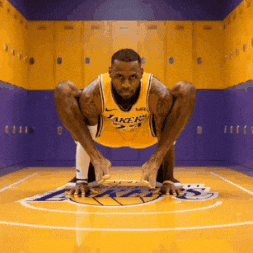 A Man In A Lakers Jersey Squatting On The Court GIF