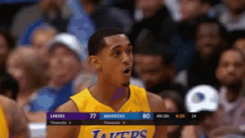 A Man In A Lakers Jersey Stands In Front Of A Crowd During A Basketball Game GIF