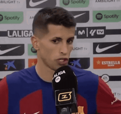 A Man In A Laliga Shirt Is Speaking Into A Microphone GIF