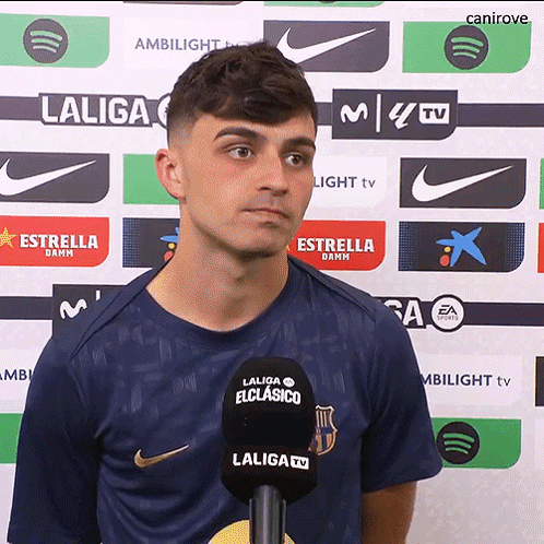 A Man In A Laliga Shirt Stands In Front Of A Backdrop GIF