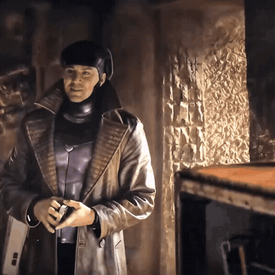A Man In A Leather Coat And Helmet Is Standing In A Room GIF