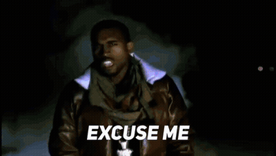 A Man In A Leather Jacket And Scarf Is Standing In Front Of A Blue Background And Says `` Excuse Me '' . GIF
