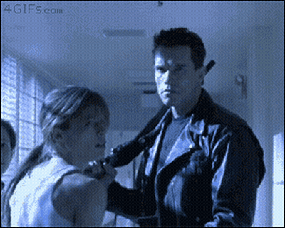 A Man In A Leather Jacket Is Holding A Woman 'S Neck In A Hallway With A 4Gifs.com Watermark GIF