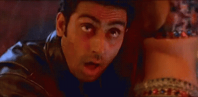 A Man In A Leather Jacket Is Looking At A Woman 'S Feet And Making A Funny Face . GIF