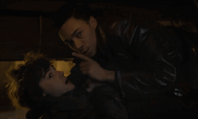 A Man In A Leather Jacket Is Pointing At Another Man 'S Face GIF