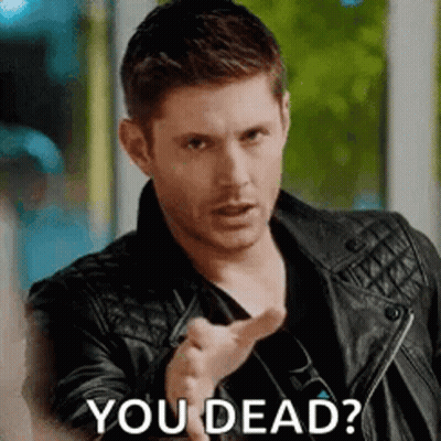 A Man In A Leather Jacket Is Pointing At The Camera And Asking If He Is Dead . GIF