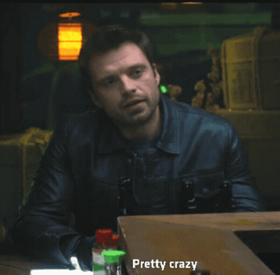 A Man In A Leather Jacket Is Sitting At A Table With Bottles And Says Pretty Crazy GIF