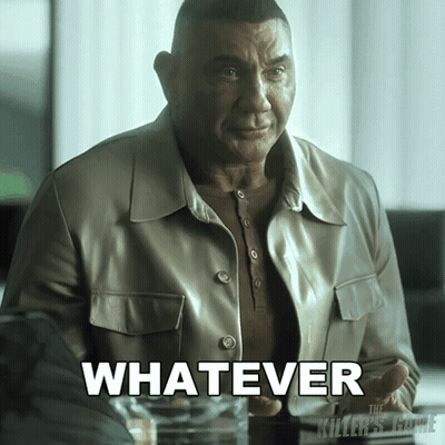 A Man In A Leather Jacket Is Sitting At A Table With The Word Whatever In White Letters GIF