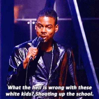 A Man In A Leather Jacket Is Speaking Into A Microphone . GIF