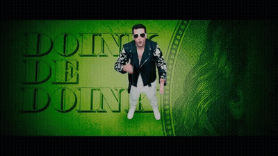 A Man In A Leather Jacket Is Standing In Front Of A Green Background That Says Doin ' De Doin ' GIF