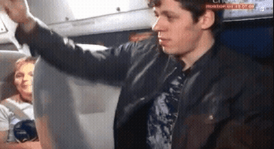 A Man In A Leather Jacket Is Standing In Front Of A Screen That Says " Rostov " On It GIF