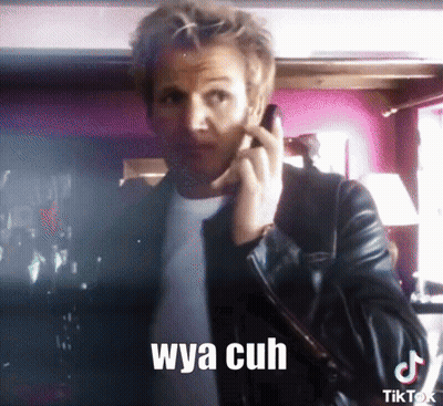 A Man In A Leather Jacket Is Talking On A Cell Phone With A Caption That Says Wya Cuh GIF