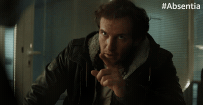A Man In A Leather Jacket Says Thank You With His Finger On His Lips GIF
