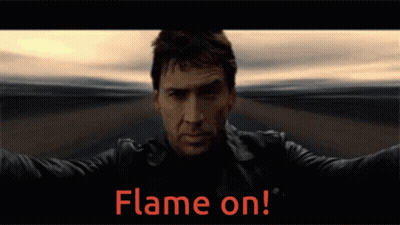 A Man In A Leather Jacket Stands In Front Of A Flame On Sign GIF