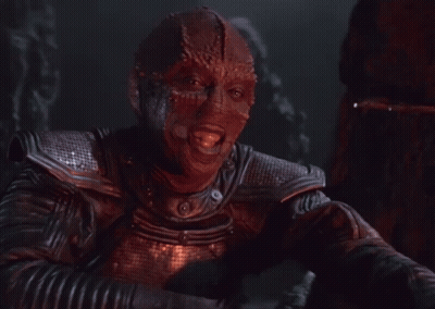 A Man In A Leather Jacket With A Red Mask On His Face GIF