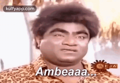 A Man In A Leopard Print Shirt Is Making A Funny Face And Says Ambeaaa . GIF