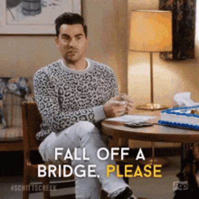 A Man In A Leopard Print Sweater Is Sitting At A Table And Saying Fall Off A Bridge Please GIF