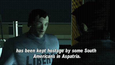 A Man In A Liberty Shirt Talks To Another Man In A Dark Room GIF