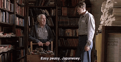 A Man In A Library Talking To An Older Man Who Is Carrying A Basket Full Of Books . GIF