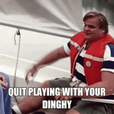 A Man In A Life Jacket Is Sitting On A Boat With The Words `` Quit Playing With Your Dinghy '' . GIF