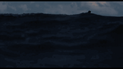 A Man In A Life Preserver Is Floating In The Ocean GIF