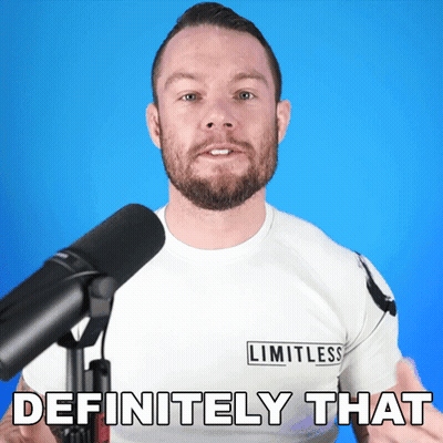 A Man In A Limitless Shirt Stands In Front Of A Microphone GIF