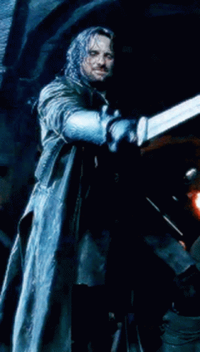 A Man In A Long Coat Is Holding A Blue Object In His Hand GIF