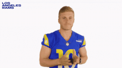 A Man In A Los Angeles Rams Jersey Is Shrugging GIF