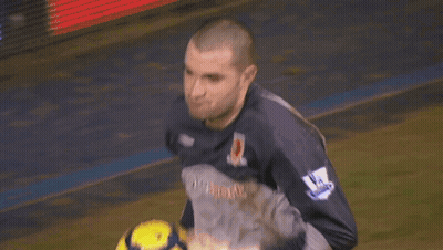 A Man In A Lottosport Jersey Holds A Soccer Ball In His Hands GIF