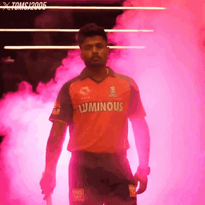 A Man In A Luminous Shirt Stands In A Pink Smokey Room GIF