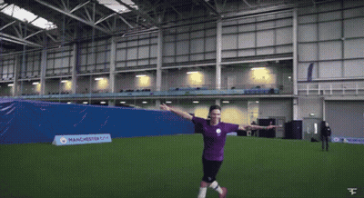 A Man In A Manchester City Jersey Kicks A Soccer Ball On A Field GIF