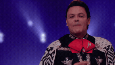 A Man In A Mariachi Outfit Has A Red Bow Tie With The Letter D On It GIF