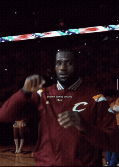 A Man In A Maroon Adidas Shirt Is Making A 666 Sign GIF