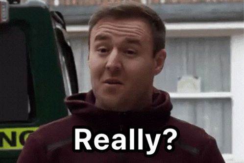 A Man In A Maroon Hoodie Is Standing In Front Of A Green Vehicle And Says Really ? GIF
