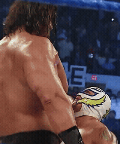 A Man In A Mask Is Being Punched By Another Man GIF