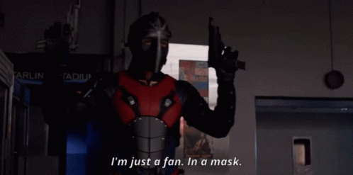 A Man In A Mask Is Holding A Gun And Says " I 'M Just A Fan In A Mask " GIF