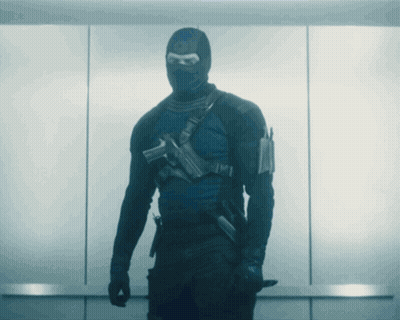 A Man In A Mask Is Holding A Knife GIF