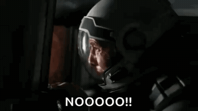 A Man In A Mask Is Looking At A Computer Screen And Saying Nooooo ! GIF