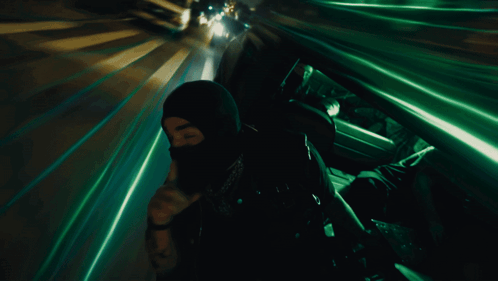 A Man In A Mask Is Making A Silence Gesture GIF
