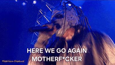 A Man In A Mask Is Singing Into A Microphone With The Words Here We Go Again Motherfucker Written Below Him GIF