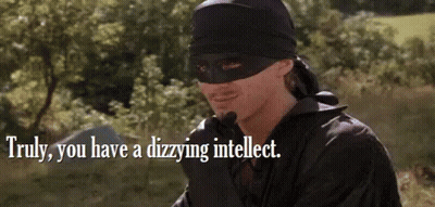 A Man In A Mask Is Standing In A Field With A Quote . GIF